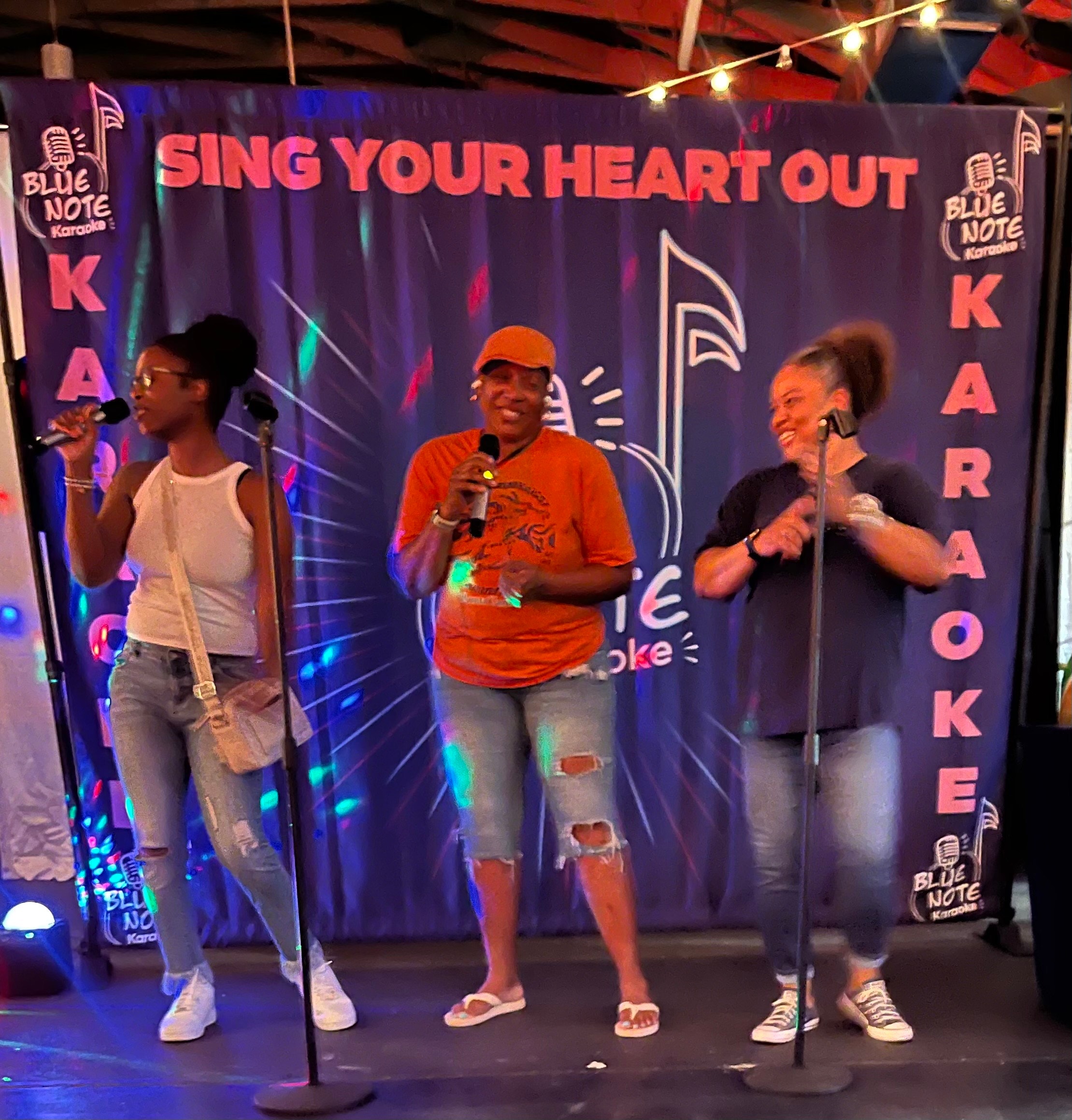 Gospel karaoke performers at Blue Note Karaoke backdrop